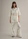 White wide leg cotton blend trousers with perforated texture_1