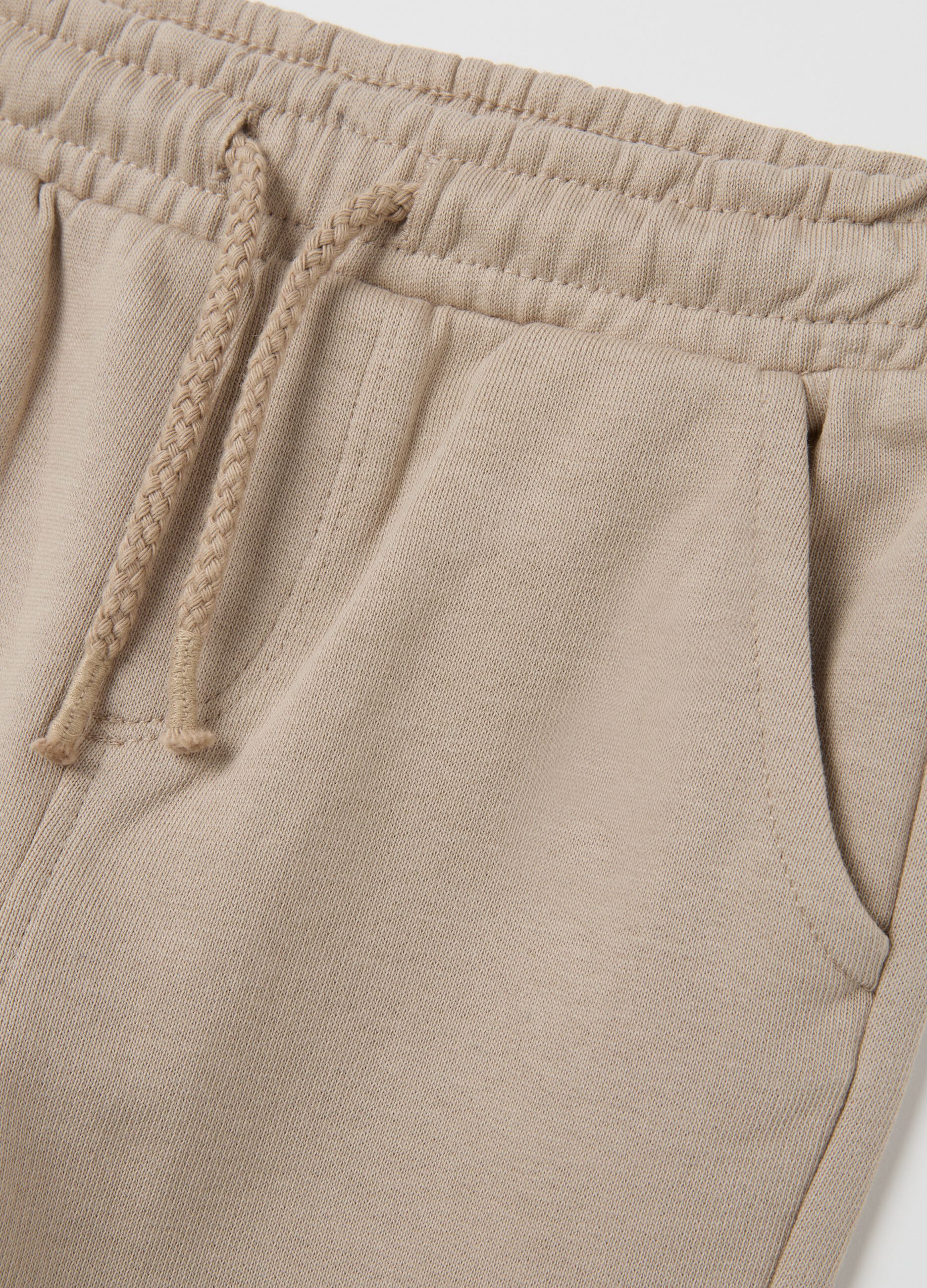 Baby trousers in pure beige cotton with dog print