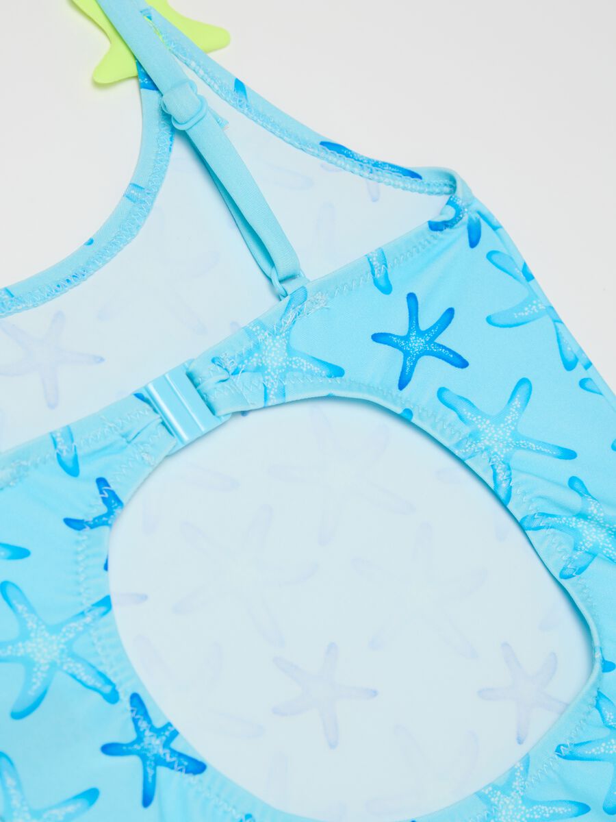 Girls’ one-piece swimsuit in light blue stretch fabric with starfish design_3