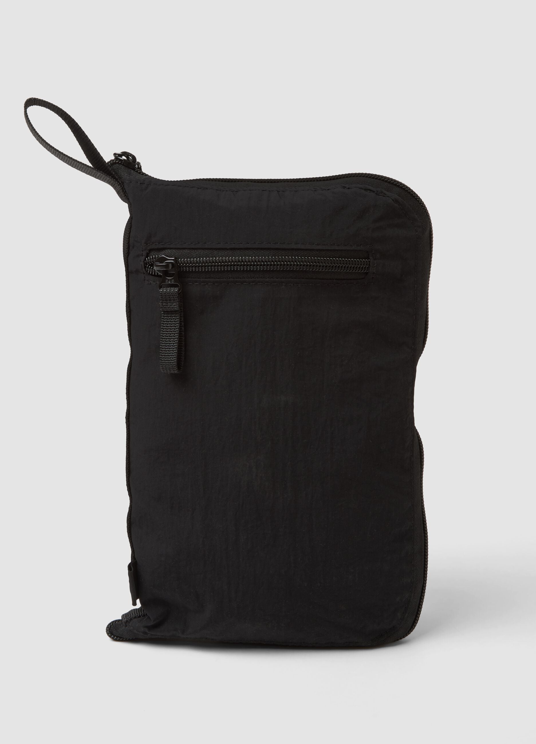 Black foldable travel bag with shoulder strap and zipped pockets