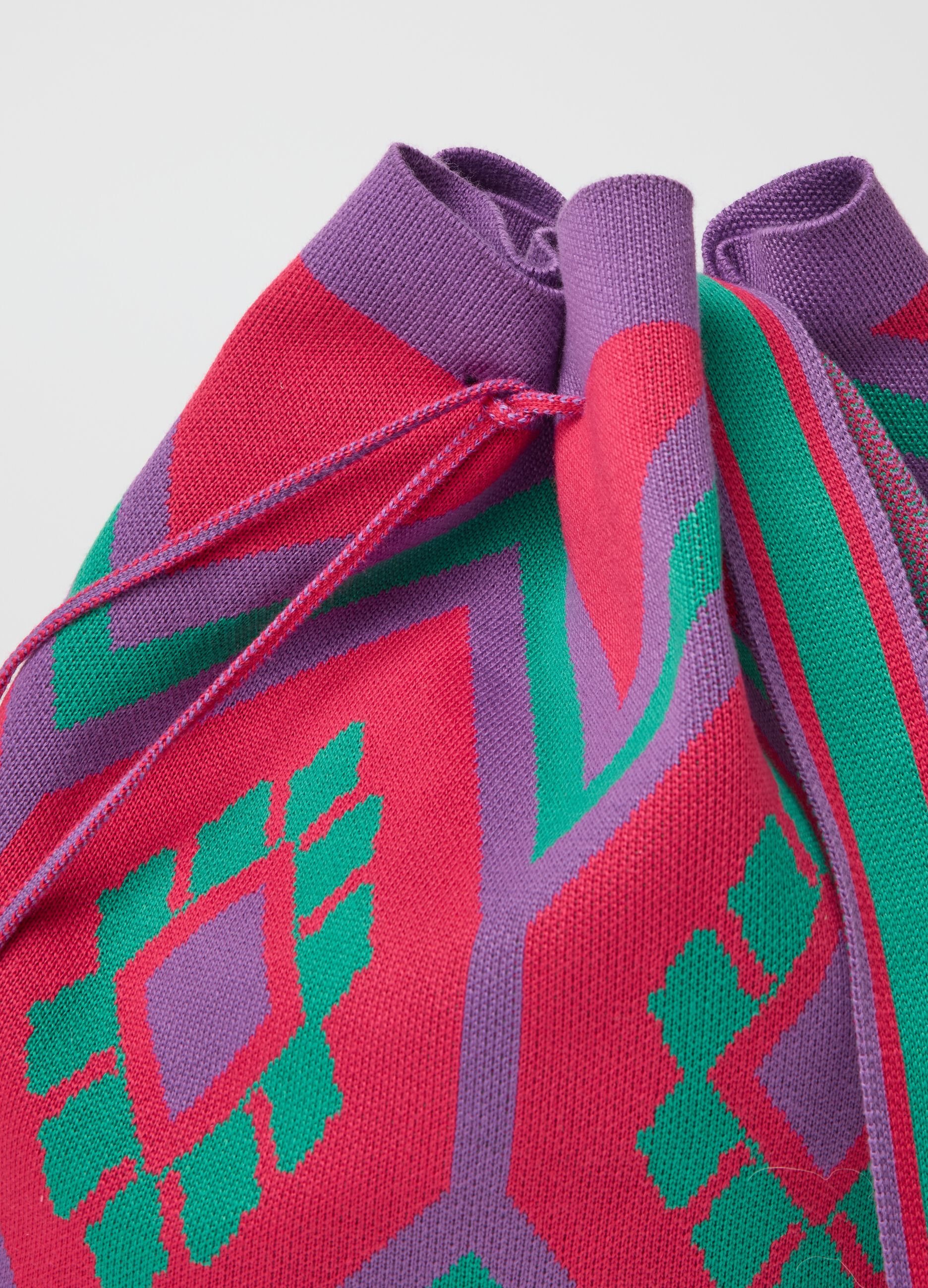 Shoulder bag with geometric motif and tassels